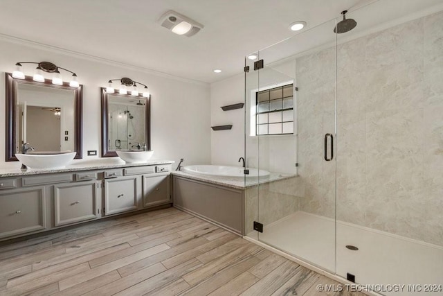 bathroom with shower with separate bathtub, vanity, hardwood / wood-style flooring, and ornamental molding