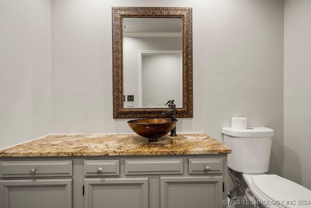 half bathroom with toilet and vanity