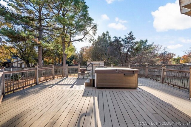 wooden terrace featuring a hot tub