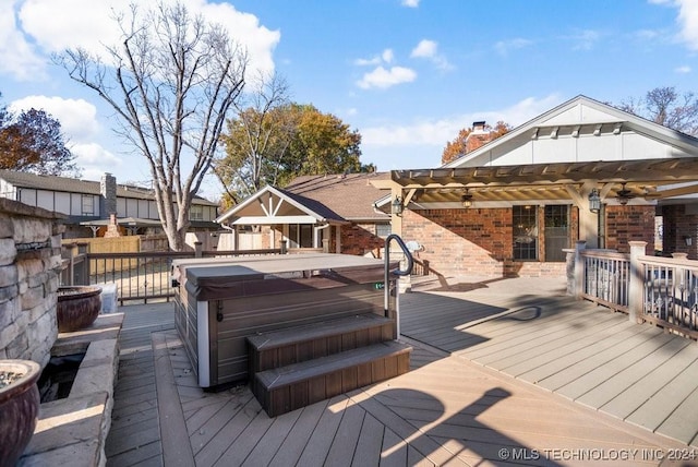 wooden terrace with a pergola and a hot tub