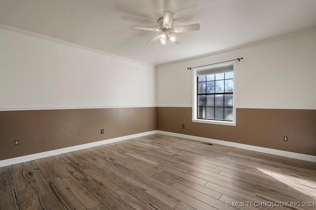 spare room featuring ceiling fan, wood-type flooring, and crown molding