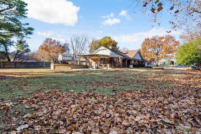 rear view of house featuring a lawn