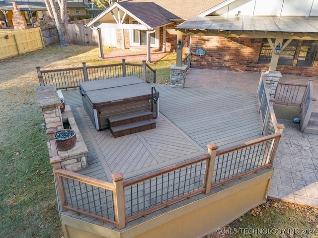 wooden deck with a yard, a patio, and a hot tub