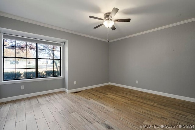 unfurnished room with ceiling fan, light wood-type flooring, and crown molding