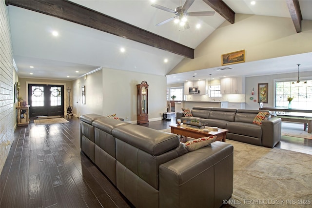 living area with high vaulted ceiling, wood finished floors, beam ceiling, and a healthy amount of sunlight