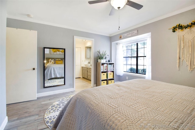 bedroom with light wood finished floors, ornamental molding, connected bathroom, ceiling fan, and baseboards