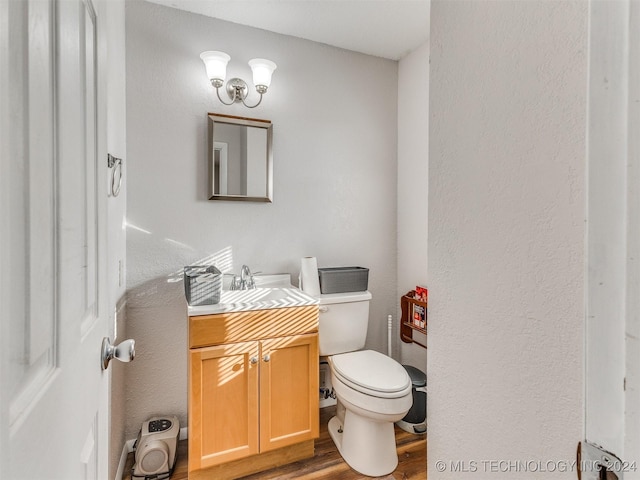 bathroom featuring hardwood / wood-style floors, vanity, and toilet