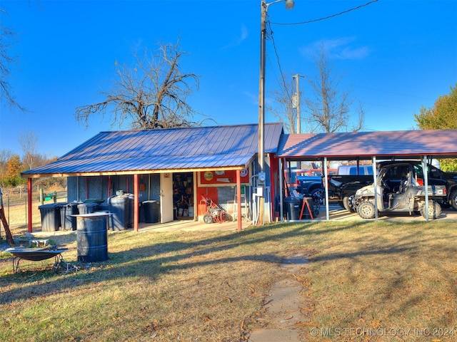 view of outdoor structure featuring a yard and a carport