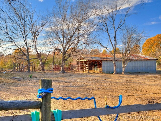 view of yard featuring fence, an outbuilding, and an outdoor structure