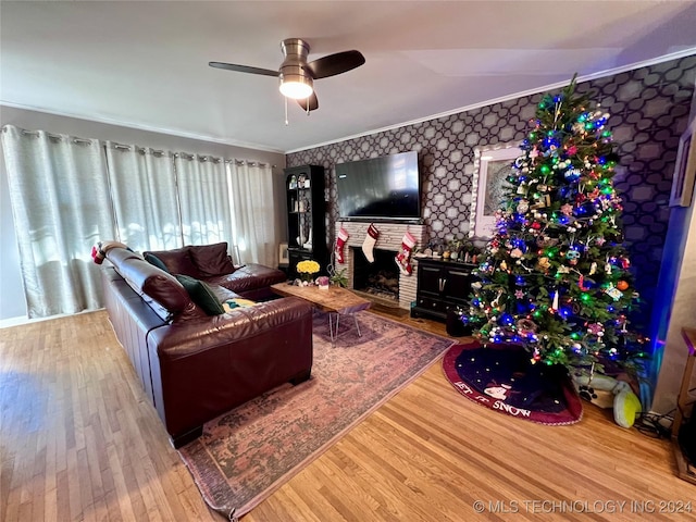 living room with ceiling fan, wood-type flooring, and crown molding