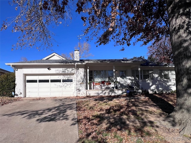 ranch-style house featuring a porch and a garage