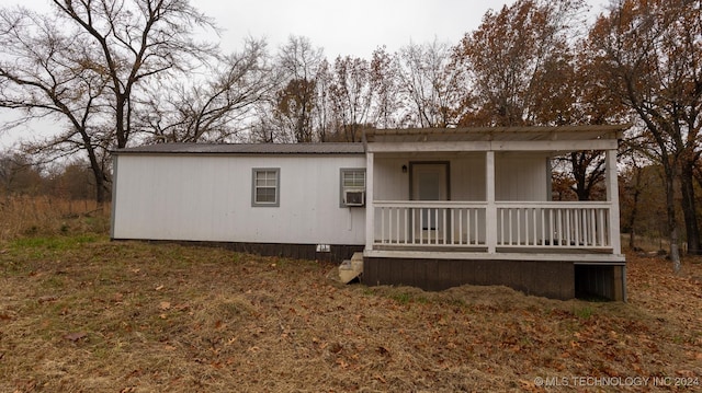 back of property with covered porch