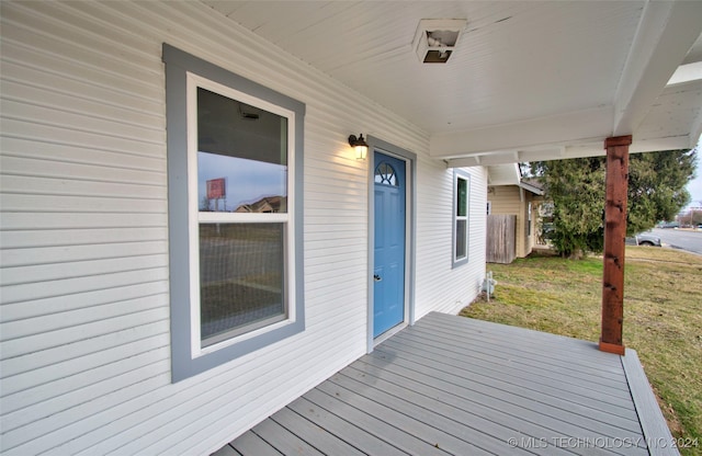 deck with a porch and a lawn