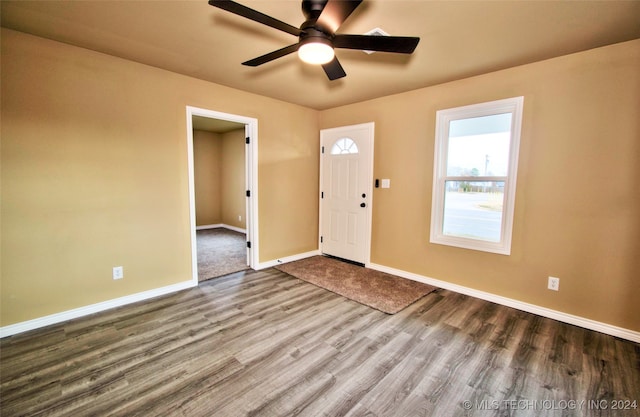 foyer with ceiling fan and wood-type flooring