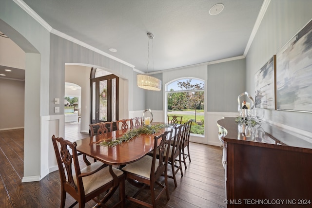 dining area with ornamental molding and dark hardwood / wood-style floors