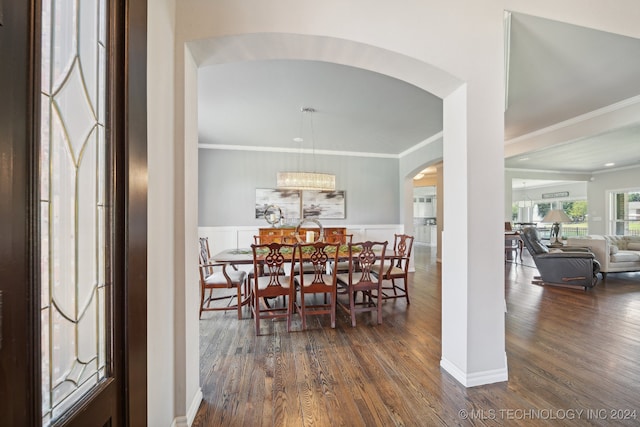 dining room featuring ornamental molding and dark hardwood / wood-style floors