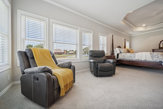 bedroom featuring crown molding, light colored carpet, and a tray ceiling