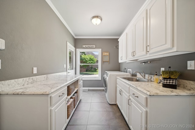 clothes washing area with washer and dryer, sink, cabinets, ornamental molding, and tile patterned floors