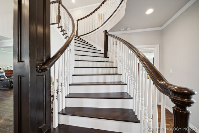 stairway with hardwood / wood-style flooring and ornamental molding