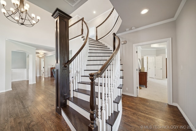 stairs featuring wood-type flooring and ornamental molding