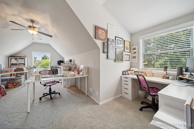 carpeted office with lofted ceiling and ceiling fan