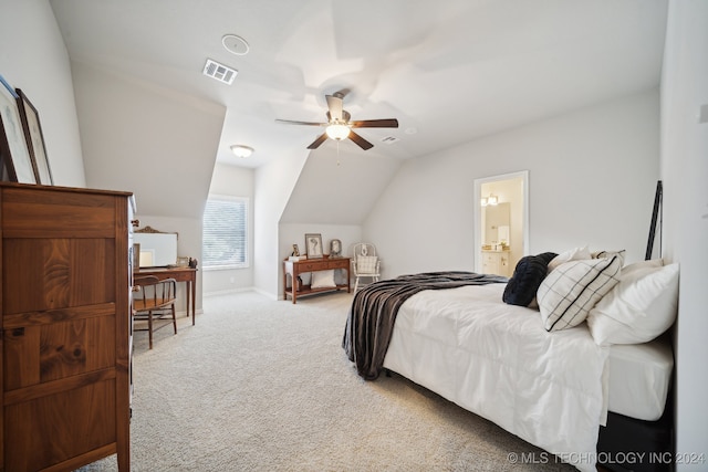 bedroom featuring vaulted ceiling, light carpet, connected bathroom, and ceiling fan