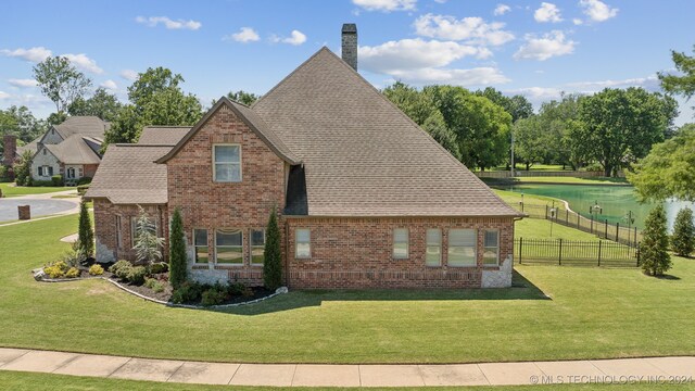 view of side of home with a lawn