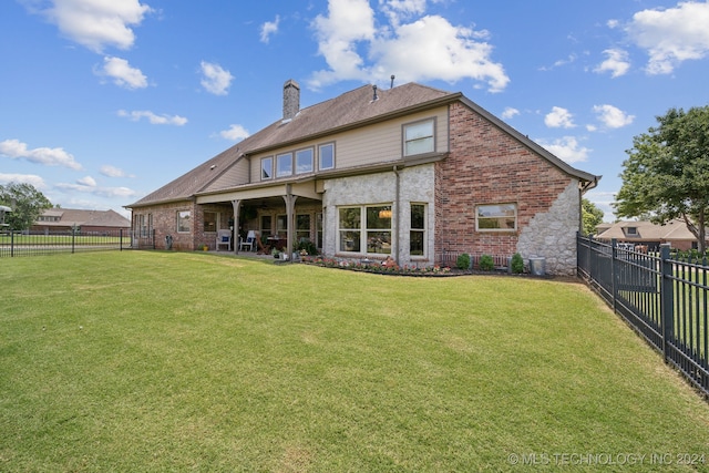 back of property featuring a lawn