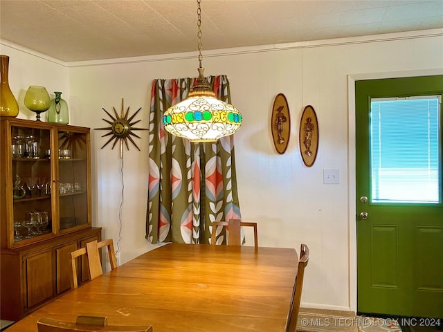 dining area featuring crown molding