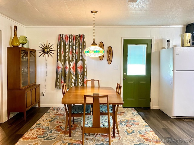 dining room with dark hardwood / wood-style flooring and ornamental molding