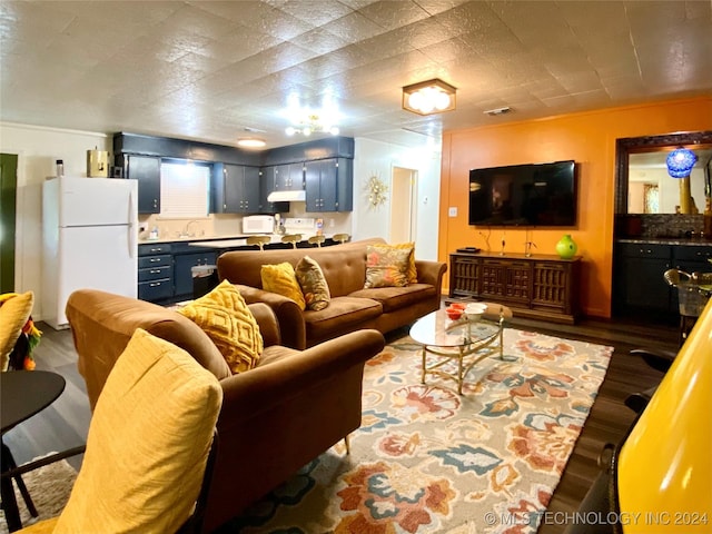 living room featuring hardwood / wood-style flooring and sink