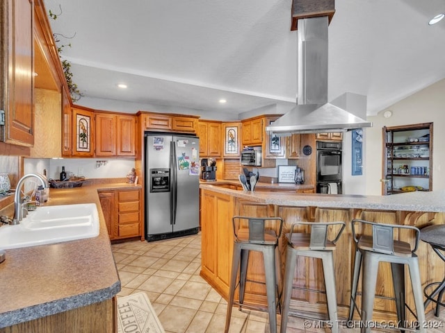 kitchen featuring sink, a kitchen breakfast bar, island exhaust hood, light tile patterned floors, and appliances with stainless steel finishes