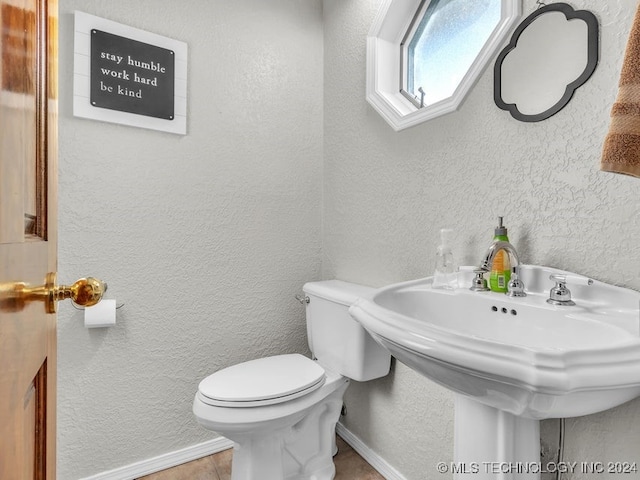 bathroom with tile patterned flooring and toilet