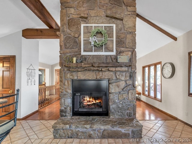 details with hardwood / wood-style floors, beam ceiling, and a stone fireplace