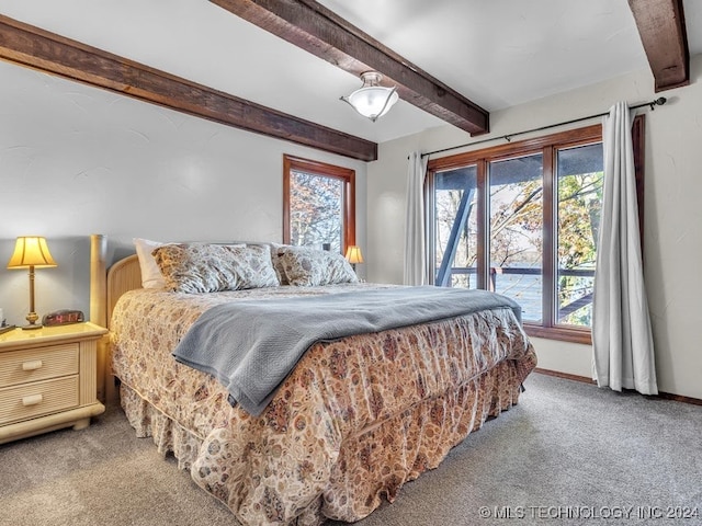 carpeted bedroom with beamed ceiling