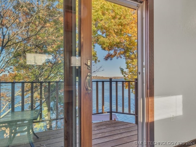 doorway to outside featuring a water view