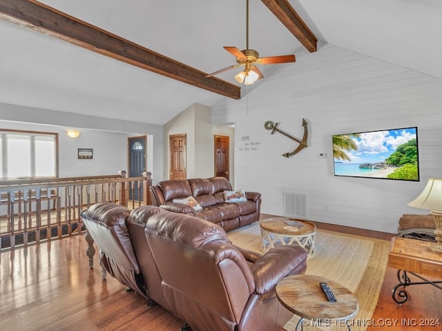 living room featuring lofted ceiling with beams, ceiling fan, and wood-type flooring