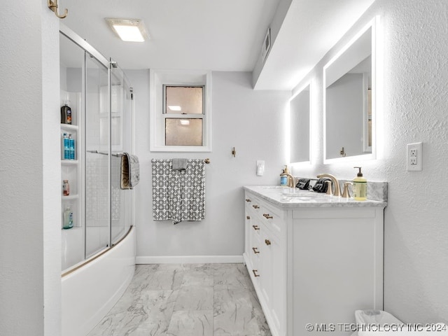 bathroom with shower / bath combination with glass door and vanity