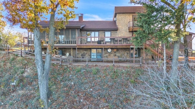 rear view of property featuring a balcony