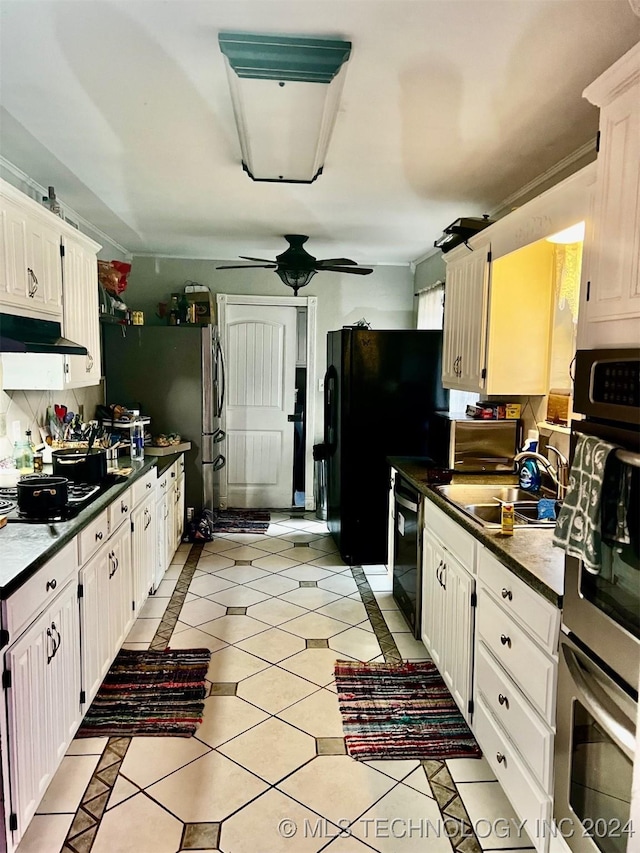 kitchen featuring appliances with stainless steel finishes, ceiling fan, sink, light tile patterned floors, and white cabinets