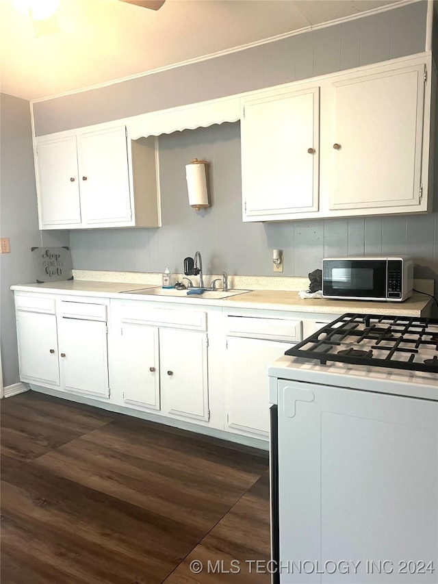 kitchen with white cabinetry, sink, range, and dark wood-type flooring