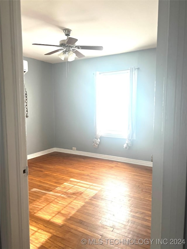 empty room featuring ceiling fan and wood-type flooring