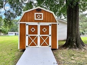 view of outbuilding with a lawn