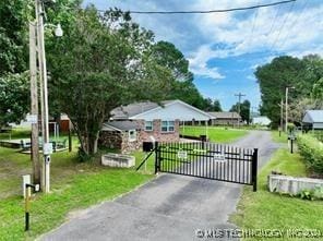 view of gate with a yard