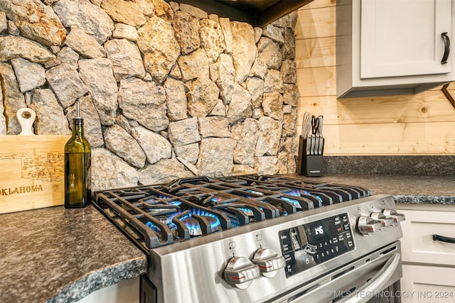 details featuring white cabinetry and stainless steel range with gas cooktop