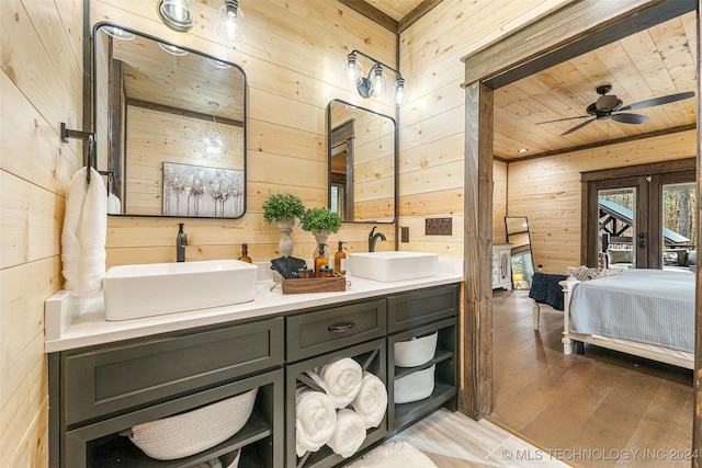 bathroom featuring ceiling fan, hardwood / wood-style floors, wooden walls, vanity, and wood ceiling