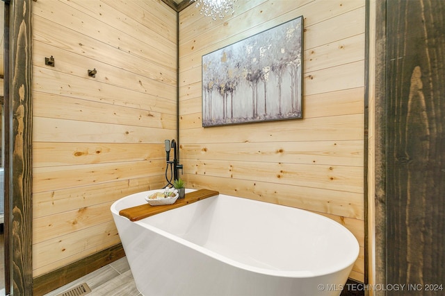 bathroom with wooden walls and a washtub