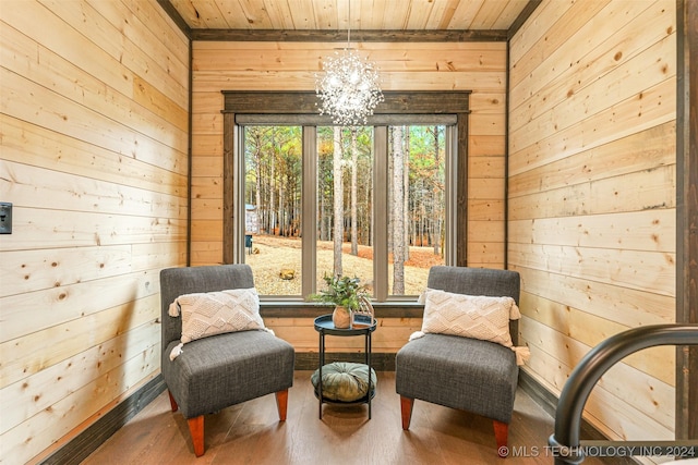 sitting room with hardwood / wood-style flooring, wood ceiling, and wooden walls