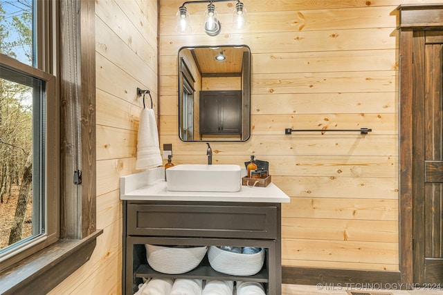 bathroom featuring vanity and wooden walls