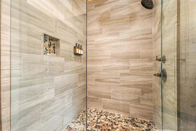 bathroom with a tile shower